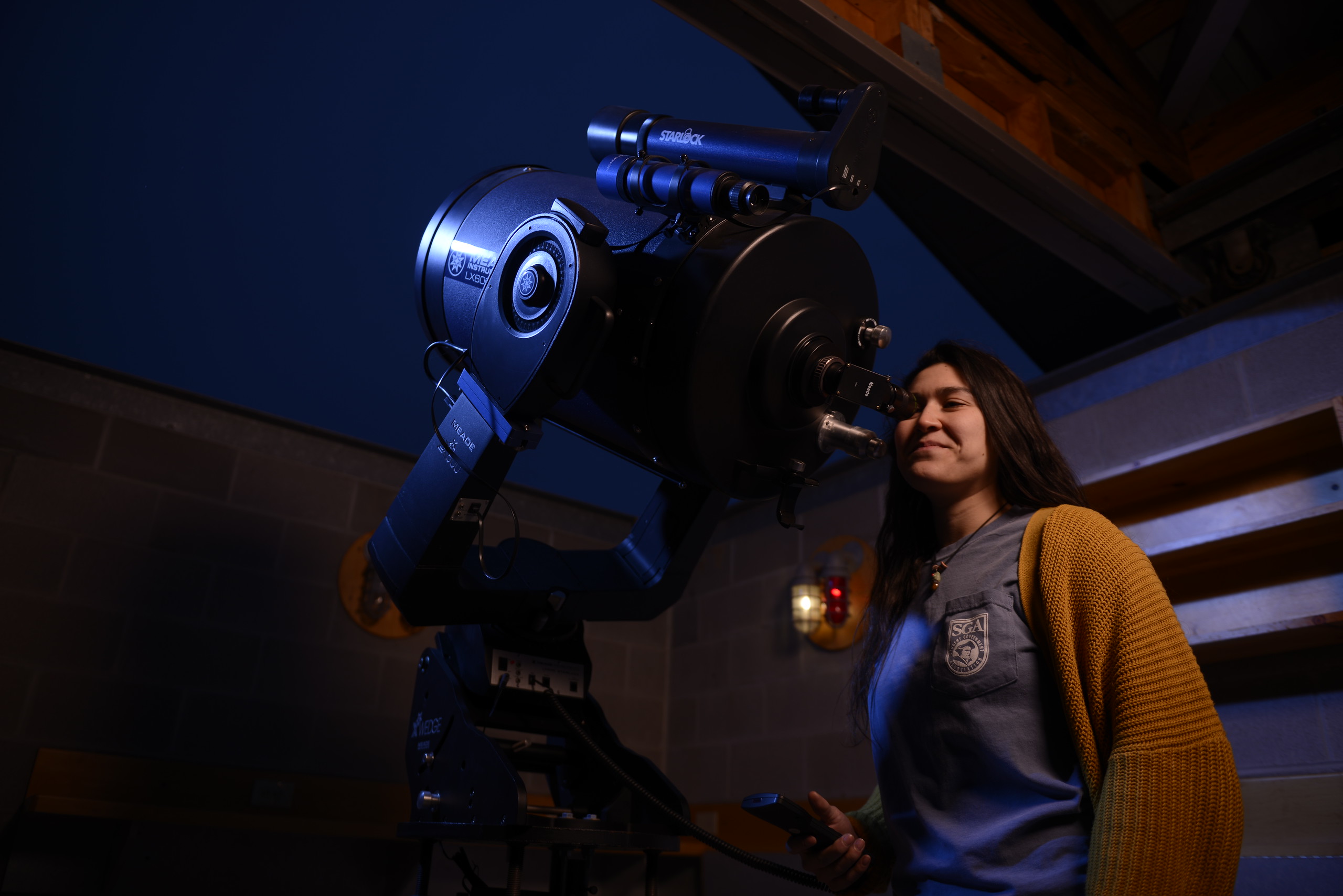 student using telescope